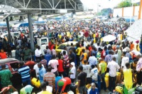 People-waiting-to-buy-fuel-at-a-filling-station-along-the-Lagos-Ibadan-Expressway-Lagos-...-on-Monday-360x239